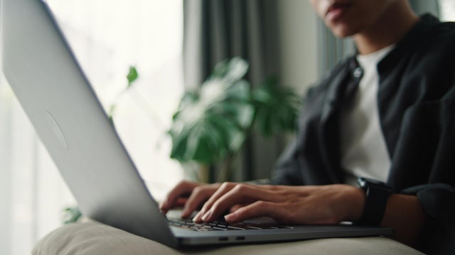 Teenager using laptop. 