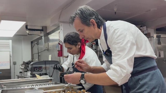 Two people preparing food 
