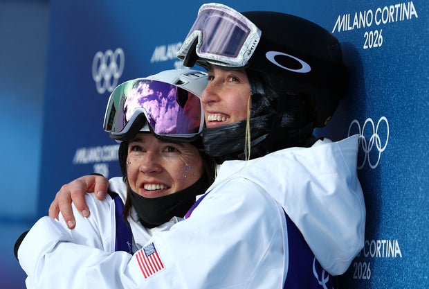 Jaelin Kauf and Elizabeth Lemley of Team USA hug each other after their runs in the women's moguls finals at the Winter Olympics in Livigno, Italy, Feb. 11, 2026. 