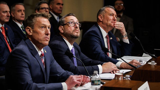 U.S. Customs and Border Protection Commissioner Rodney Scott, U.S. Citizenship and Immigration Services Director Joseph Edlow, and Acting Immigration and Customs Enforcement Director Todd Lyons watch a video clip during a House Homeland Security Committee 