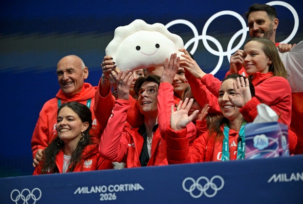 Poland's Vladimir Samoilov (bottom row, C) gestures in the kiss and cry area after competing in the figure skating team event men's singles short program during the Milano Cortina 2026 Winter Olympic Games at Milano Ice Skating Arena in Milan on February 7, 2026. 