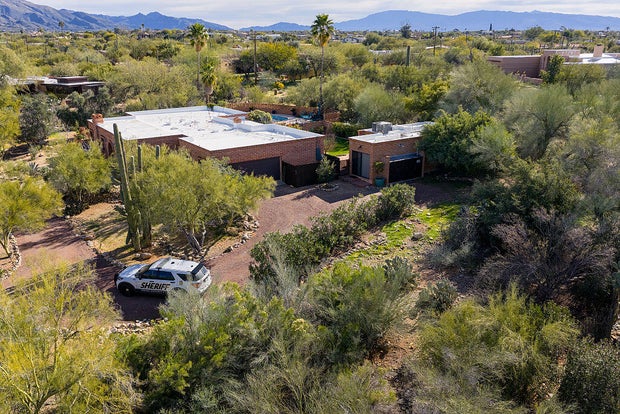In an aerial view, a Pima County sheriff's deputy keeps guard outside of Nancy Guthrie's residence on Feb. 15, 2026, in Tucson, Arizona. 