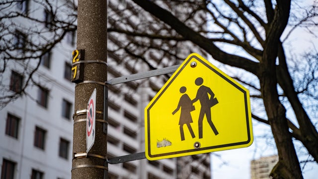 Yellow warning road sign for a school zone. 