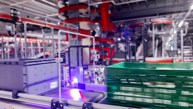 Warehouse Worker Unloading Shipment Boxes into Cargo Container Truck. Cargo Trailer Truck Parked Loading at Dock Warehouse. Delivery Service. Shipping Warehouse Logistics. Freight Truck Transportation. 