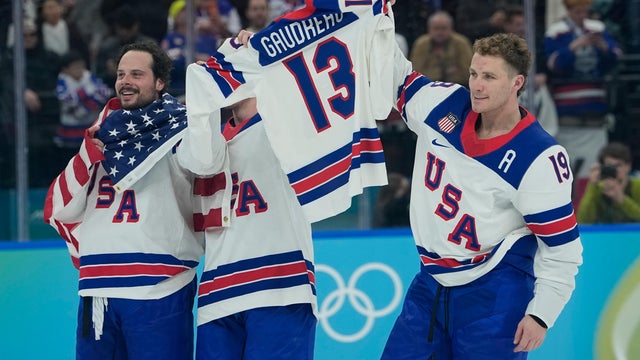 United States' Matthew Tkachuk (19), right, celebrates after the United States defeated Canada in a men's ice hockey gold medal game between Canada and the United States at the 2026 Winter Olympics, in Milan, Italy, Sunday, Feb. 22, 2026. (AP Photo/Petr David Josek) 