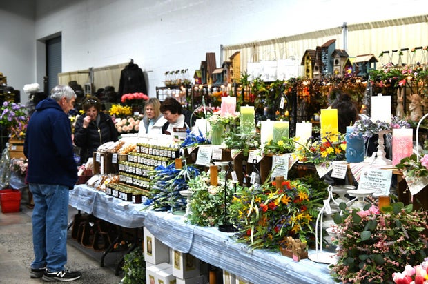People pose for a photo at the opening day of the Philly Home and Garden show 