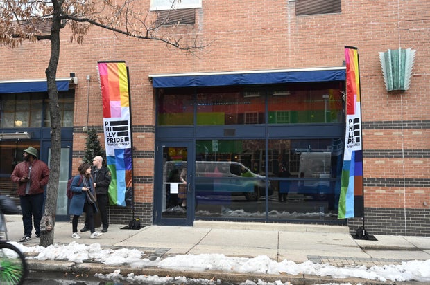 People pose for a photo at the opening of the Philly LGBTQ+ visitor center 