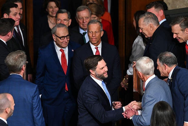 Vice President J.D. Vance, front, Sen. Chuck Schumer of New York, back left, and Sen. John Thune of South Dakota, back right, arrive for the State of the Union address at the U.S. Capitol in Washington, D.C., on Feb. 24, 2026. 