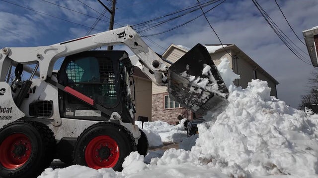 Construction vehicle with basket used to shovel snow 