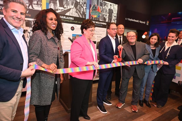 People pose for a photo at the opening of the Philly LGBTQ+ visitor center 