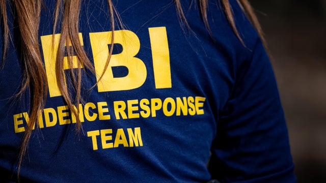 A member of the FBI's evidence response team surveils the area around Nancy Guthrie's residence on Feb. 11, 2026, in Tucson, Arizona. 