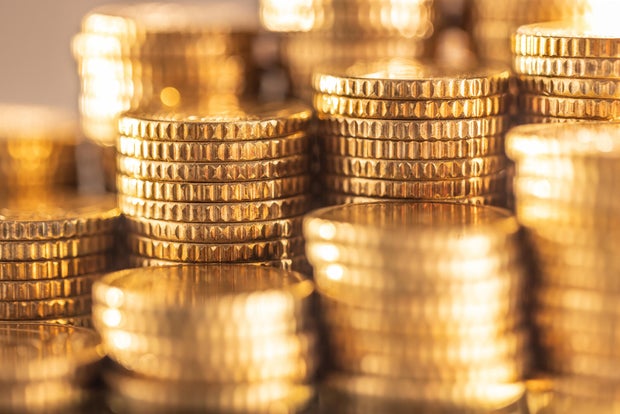 Pile of stacked shiny golden Euro coins close-up
