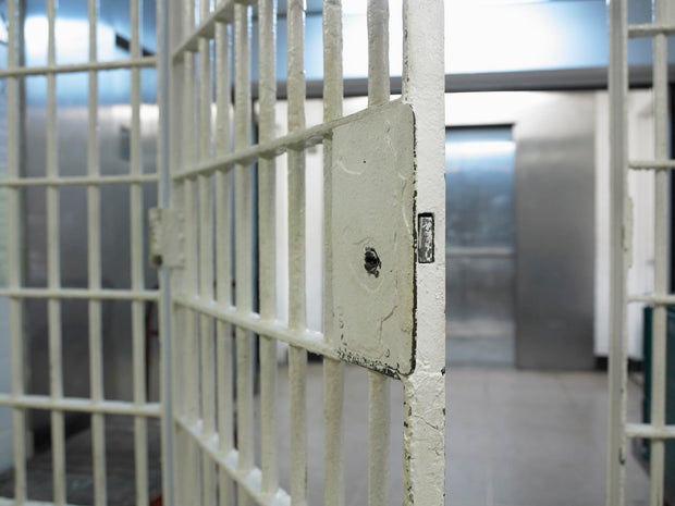 Open door to prison cell 