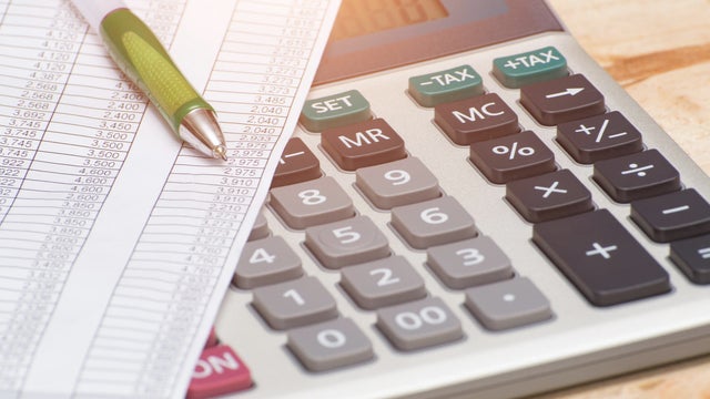 Checking the Accounts with calculator 