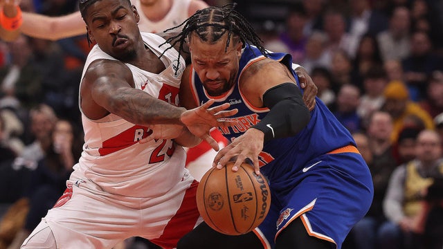 Jamal Shead #23 of the Toronto Raptors tries to get the ball from Jalen Brunson #11 of the New York Knicks as the Toronto Raptors play the New York Knicks at Scotiabank Arena in Toronto. 