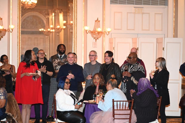 People post for photos at Alvin Ailey American Dance Theater Party at Ensemble Arts 