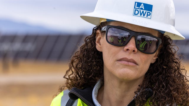 Workers install solar panels 