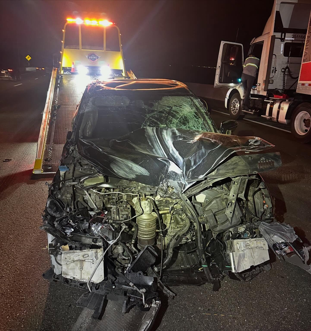 A vehicle with front-end damage after a crashing into a big rig 