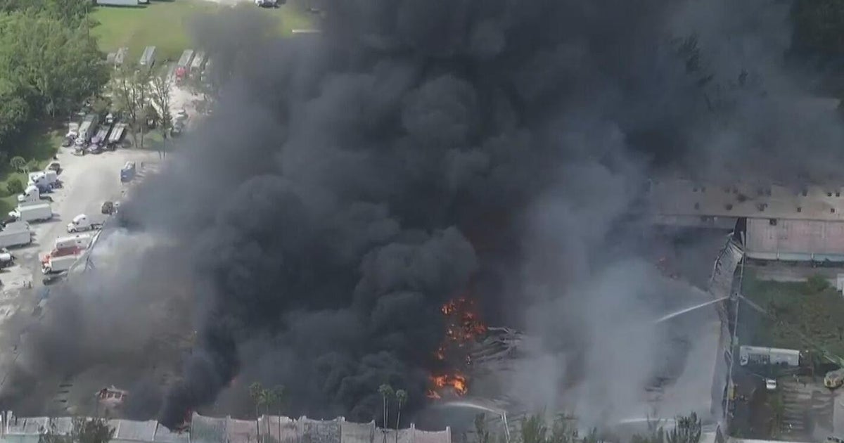 Crews race to extinguish massive warehouse fire in northwest Miami-Dade