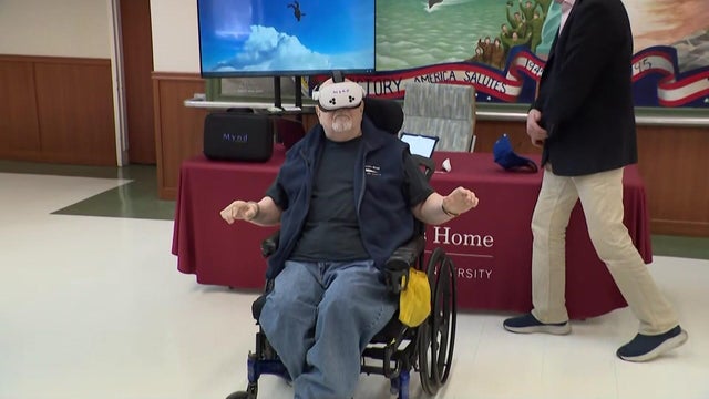 Man in wheelchair uses virtual reality goggles 