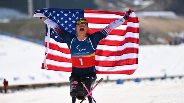 Oksana Masters of Team USA celebrates after winning gold in the Para cross-country skiing sprint sitting final at the Paralympics, March 10, 2026, in Val di Fiemme, Italy. 