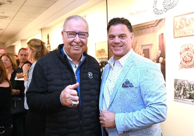 People pose for photos during an event at the National Liberty Museum 