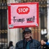 A man holds a placard against US President Donald Trump 