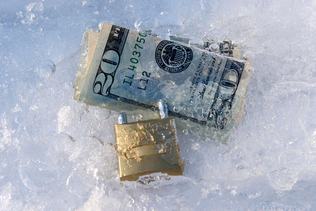 Frozen dollars with padlock 