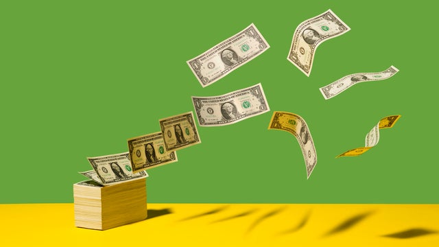 Dollar bills blowing away 