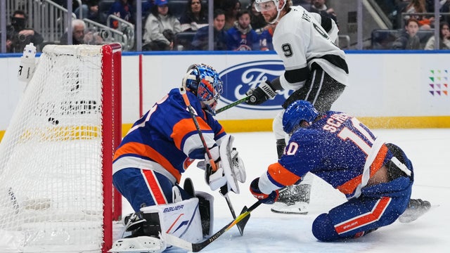 Los Angeles Kings' Adrian Kempe (9) shoots the puck, past New York Islanders goaltender Ilya Sorokin (30) and Brayden Schenn (10) for a goal during the first period of an NHL hockey game Friday, March 13, 2026, at UBS Arena in Elmont, N.Y. 