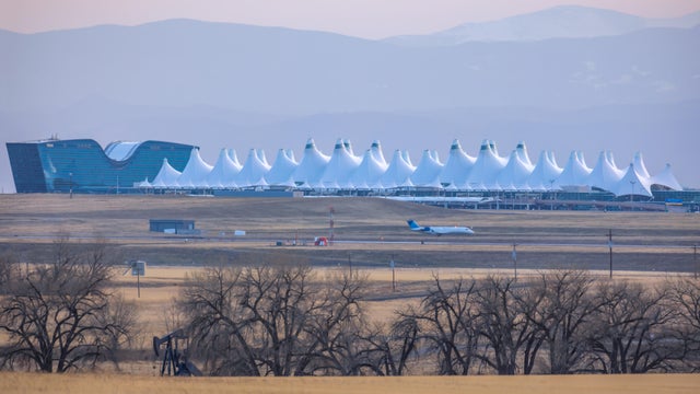 Agricultural landscape with naked spring trees and oil pump in the prairie of Eastern Colorado 