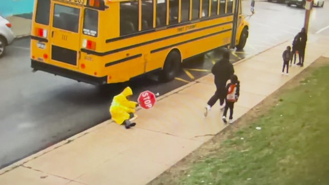 Surveillance video of the crossing guard knocked onto the ground as the attacker runs away 