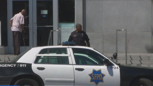a police officer walks down steps toward a patrol vehicle 