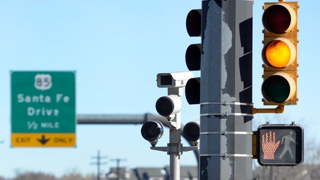 Supporters trying to ban red light cameras and photo radar cameras go door to door in Sheridan to collect signatures for a ballot measure. 