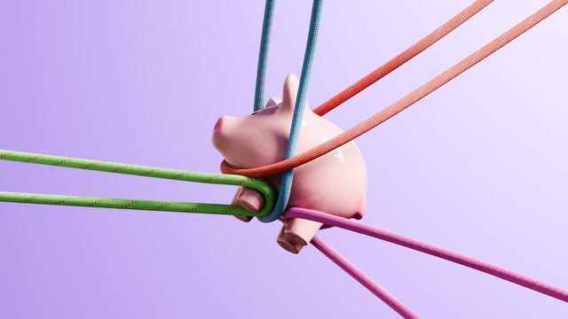Financial Strain: Piggybank Pulled in Different Directions by Colorful Ropes 