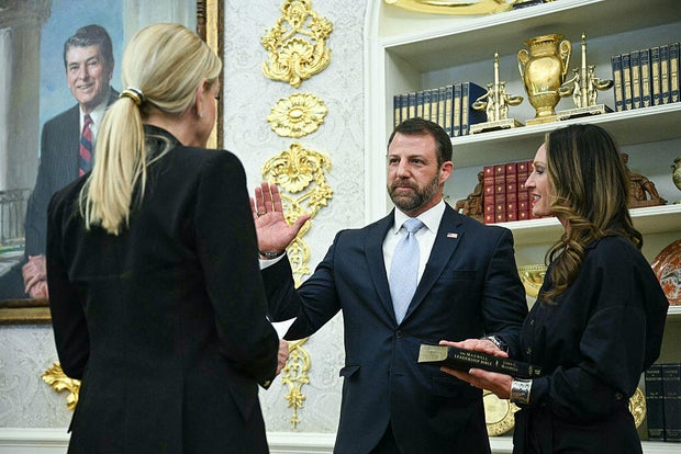 Attorney General Pam Bondi swears in Secretary of Homeland Security Markwayne Mullin, alongside his wife Christine Mullin, during a ceremony hosted by President Trump in the Oval Office of the White House in Washington, D.C., on Tuesday, March 24, 2026. 