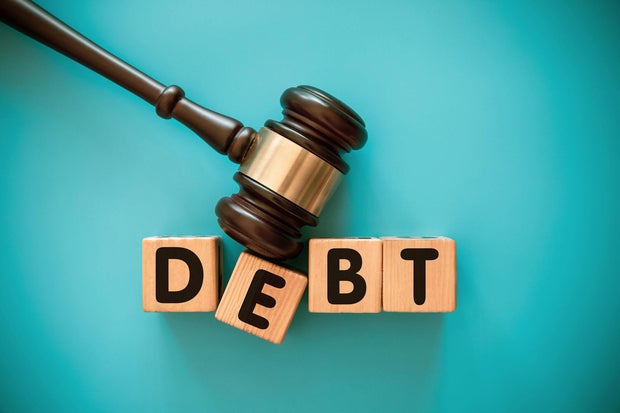 Gavel and wood block with DEBT 