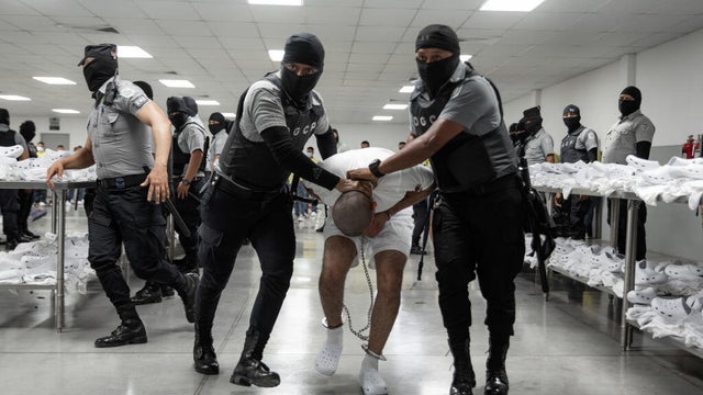 Guards escort a newly admitted inmate at the Terrorism Confinement Center (CECOT) in El Salvador on March 16, 2025. 