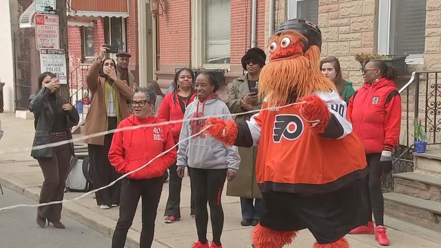 On a Point Breeze block, Gritty holds the ropes for Double Dutch 