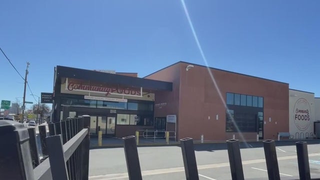 a vacant building behind a fence 