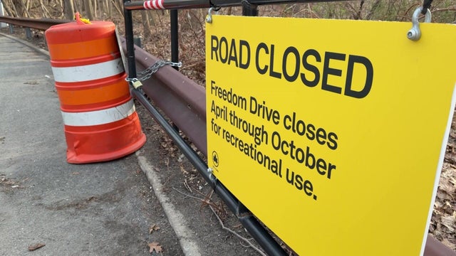 Road sign "Freedom Drive closes April through October for recreational use." 