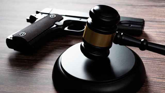 Gun and gavel on the table 