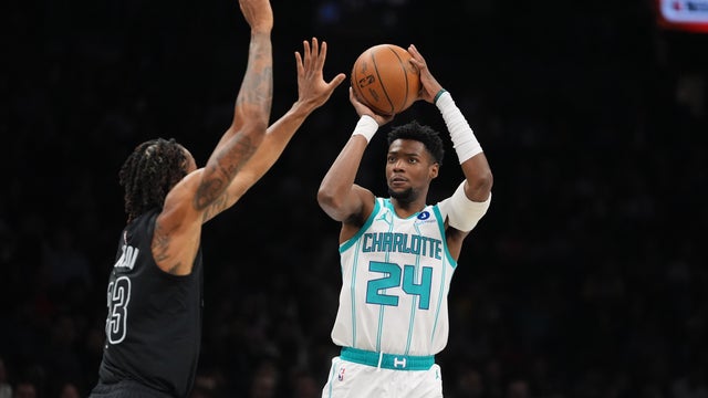 Charlotte Hornets' Brandon Miller (24) shoots over Brooklyn Nets' Nic Claxton (33) during the first half of an NBA basketball game Tuesday, March 31, 2026, in New York. 