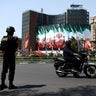 A member of a police force stands guard on a street, amid the U.S.-Israeli conflict with Iran, in Tehran 
