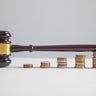 Judge gavel and coins on the table. 