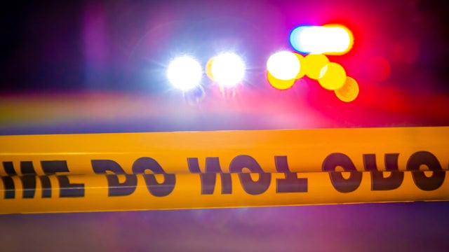 Generic police lights and yellow police tape at crime scene 