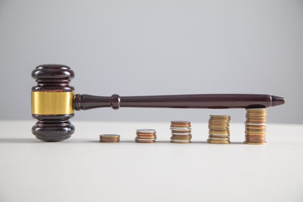 Judge gavel and coins on the table. 