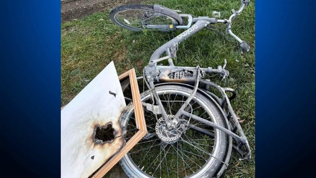 a scorched e-bike with the battery exposed after it ignited 