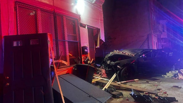 A damaged car is seen after it crashed into an apartment building in North Philadelphia 