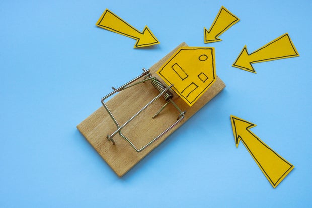 Mousetrap and house. Mortgage fraud and financial risk.